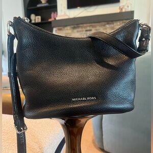 Michael Kors black purse with pockets inside and one on the outside